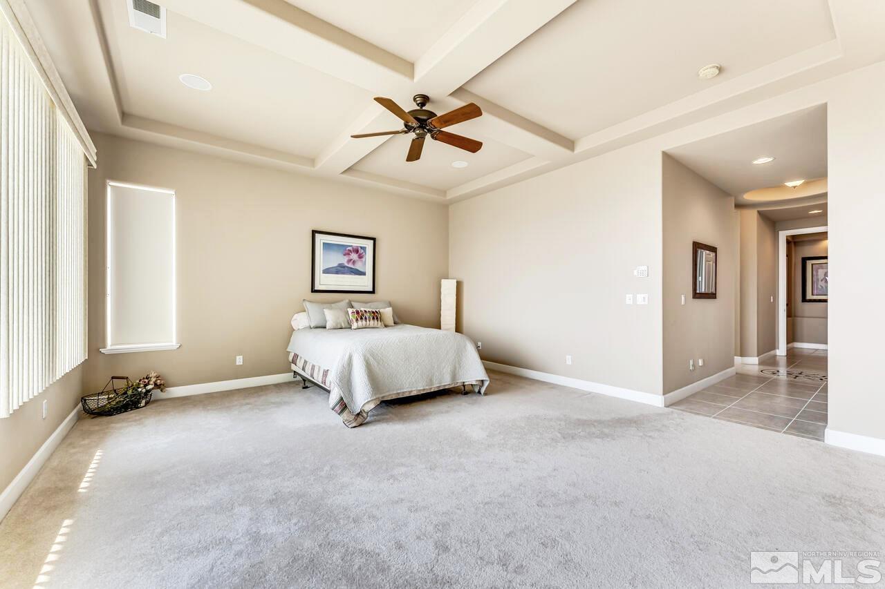 1816 Laurel Ridge Drive Reno, NV 89523 - Photo 23 of 40 a spacious bedroom with a bed and a chandelier