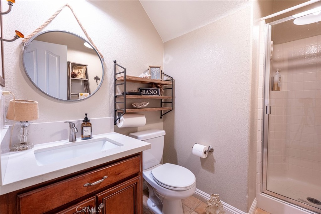 28201 Springvale Lane Castaic, CA 91384 - Photo 12 of 59 a bathroom with a sink a mirror a toilet and vanity