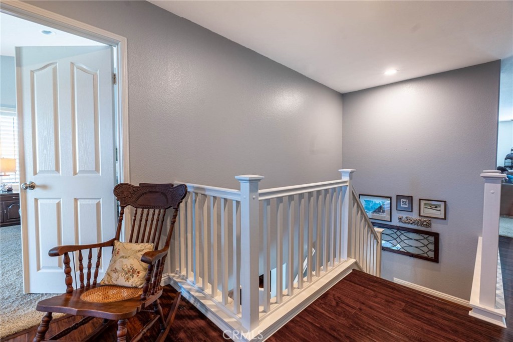 28201 Springvale Lane Castaic, CA 91384 - Photo 15 of 59 a view of a hallway with an entryway and wooden floor
