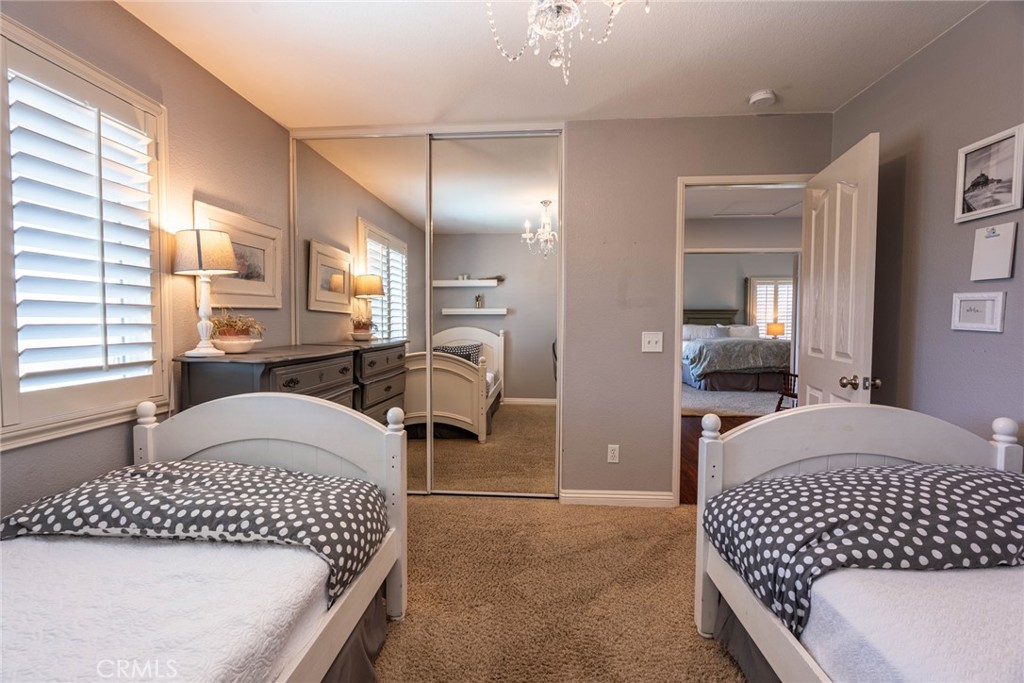 28201 Springvale Lane Castaic, CA 91384 - Photo 22 of 59 a bedroom with a bed and a large mirror