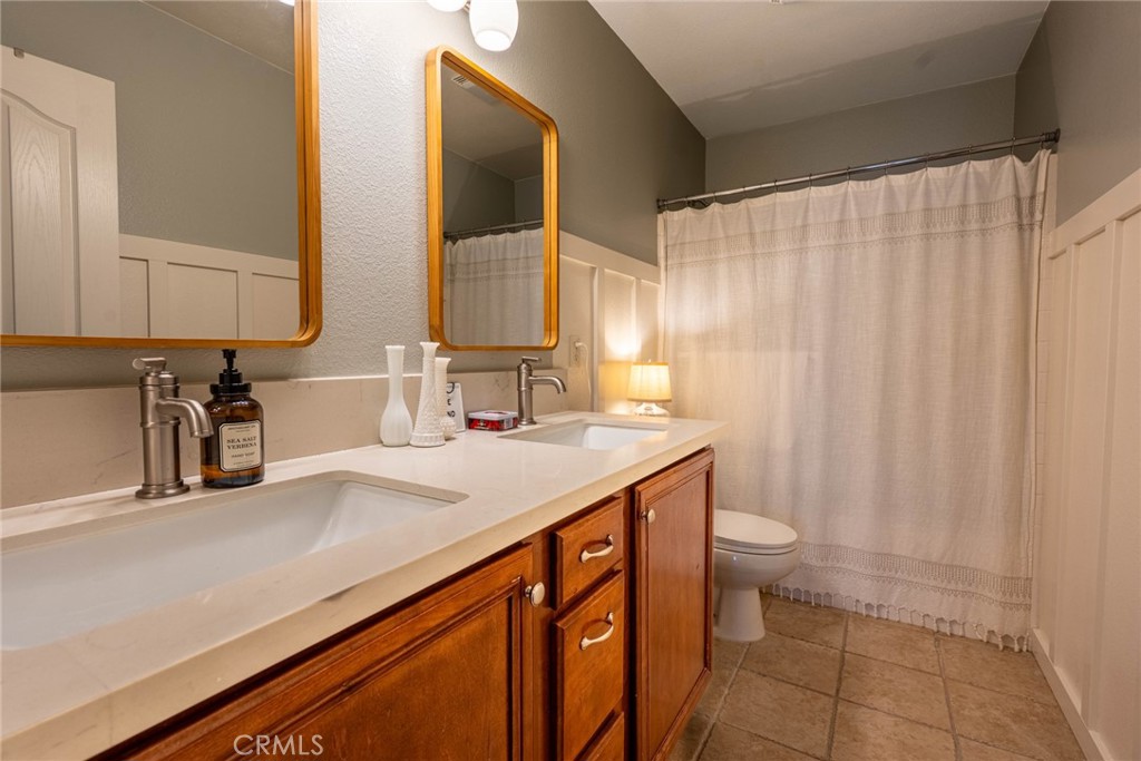 28201 Springvale Lane Castaic, CA 91384 - Photo 24 of 59 a bathroom with a sink a toilet and a mirror