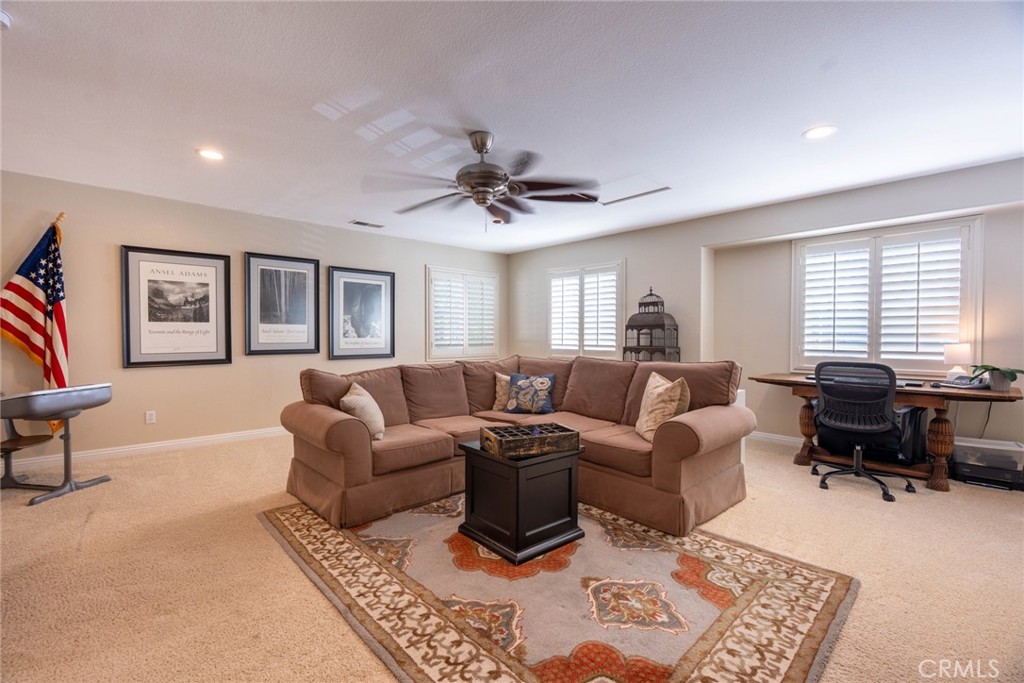 28201 Springvale Lane Castaic, CA 91384 - Photo 25 of 59 a living room with furniture a desk and chair with a bookshelf
