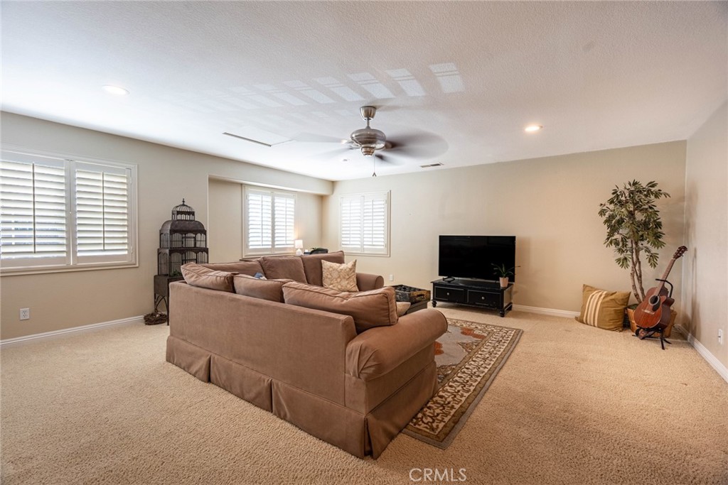 28201 Springvale Lane Castaic, CA 91384 - Photo 26 of 59 a living room with furniture a window and a flat screen tv