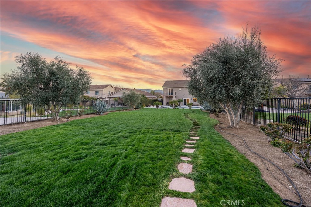 28201 Springvale Lane Castaic, CA 91384 - Photo 37 of 59 a view of backyard with table and chairs and wooden fence