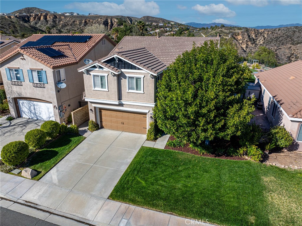 28201 Springvale Lane Castaic, CA 91384 - Photo 53 of 59 a front view of a house with a garden and plants