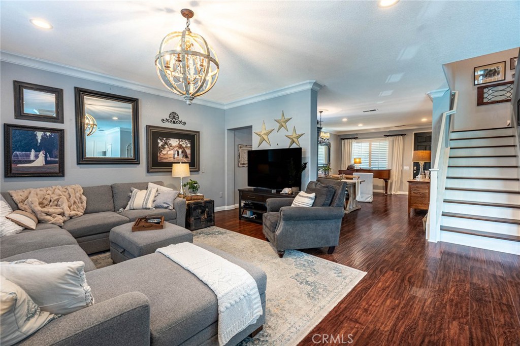 28201 Springvale Lane Castaic, CA 91384 - Photo 7 of 59 a living room with furniture a chandelier a fireplace and a flat screen tv