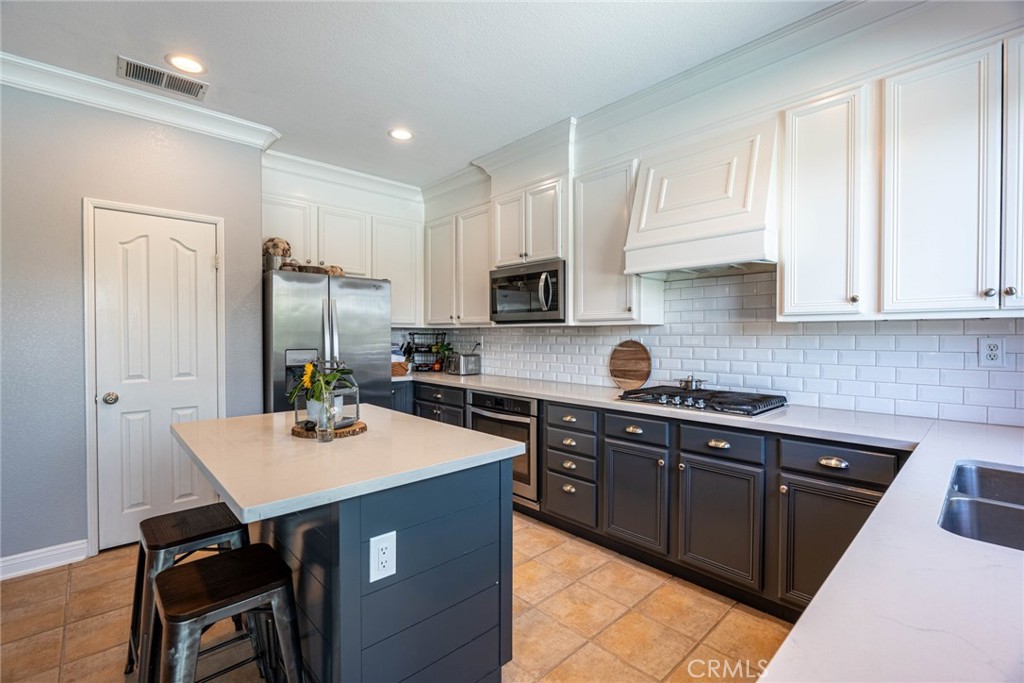 28201 Springvale Lane Castaic, CA 91384 - Photo 10 of 59 a kitchen with stainless steel appliances granite countertop a sink dishwasher a refrigerator a stove a microwave and cabinets