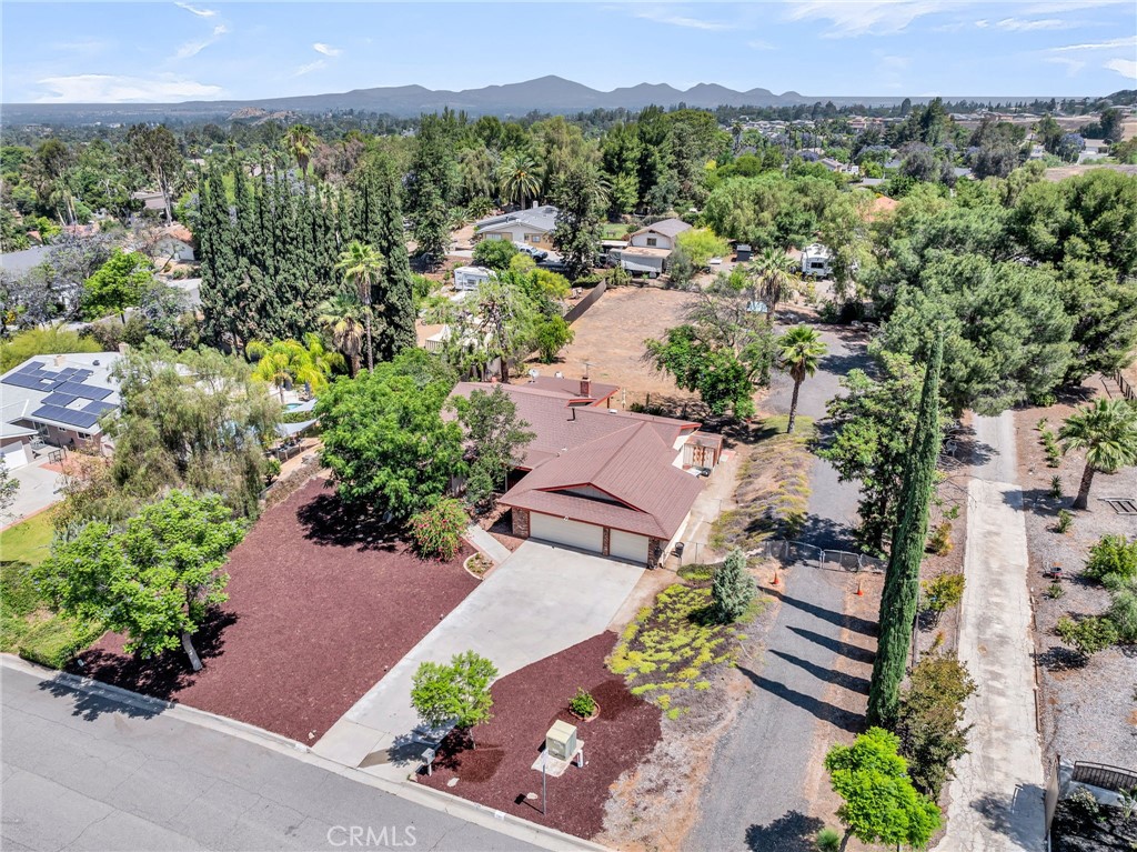 1239 Highridge Street Riverside, CA 92506 - Photo 1 of 1 an aerial view of a city with lots of residential buildings and mountain view in back