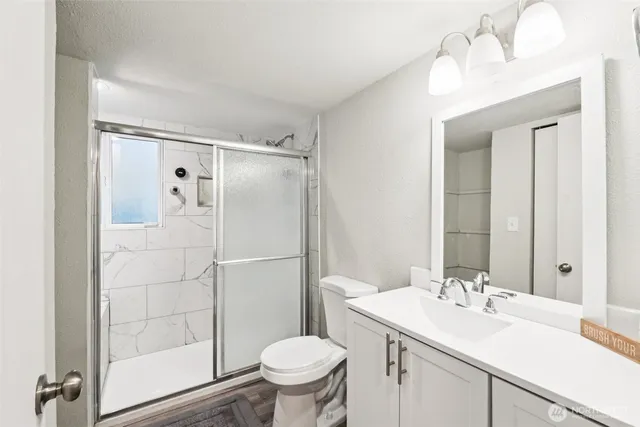 a bathroom with a sink toilet and shower