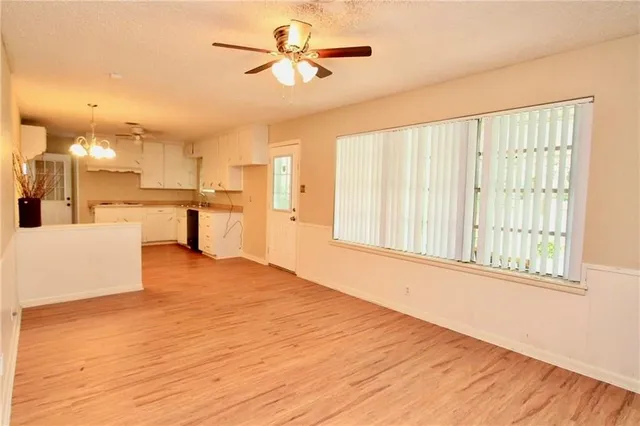 a view of a kitchen with a kitchen island wooden floor and a window