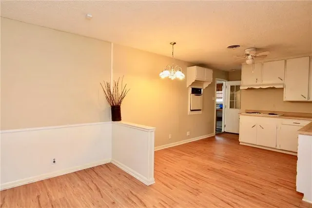 a view of a kitchen with wooden floor