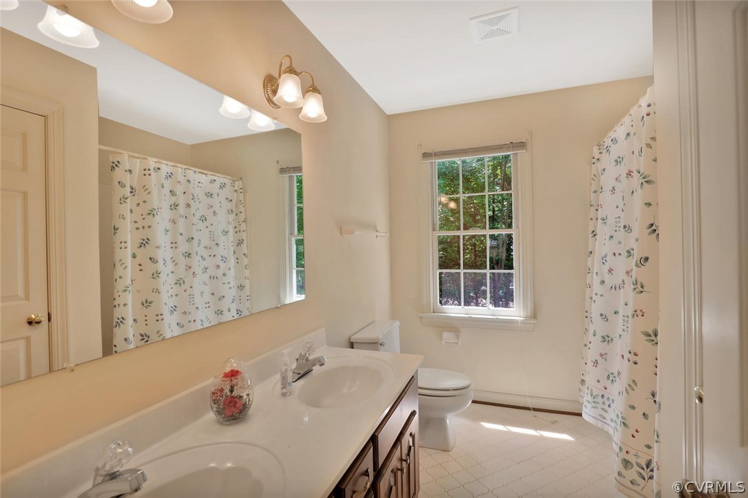 9604 St Regis Terrace North Chesterfield, VA 23236 - Photo 21 of 32 a bathroom with a tub sink and a window