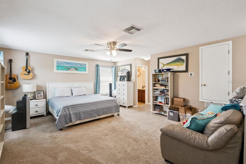 8484 Dover View Lane Orlando, FL 32829 - Photo 20 of 41 a spacious bedroom with a bed and furniture