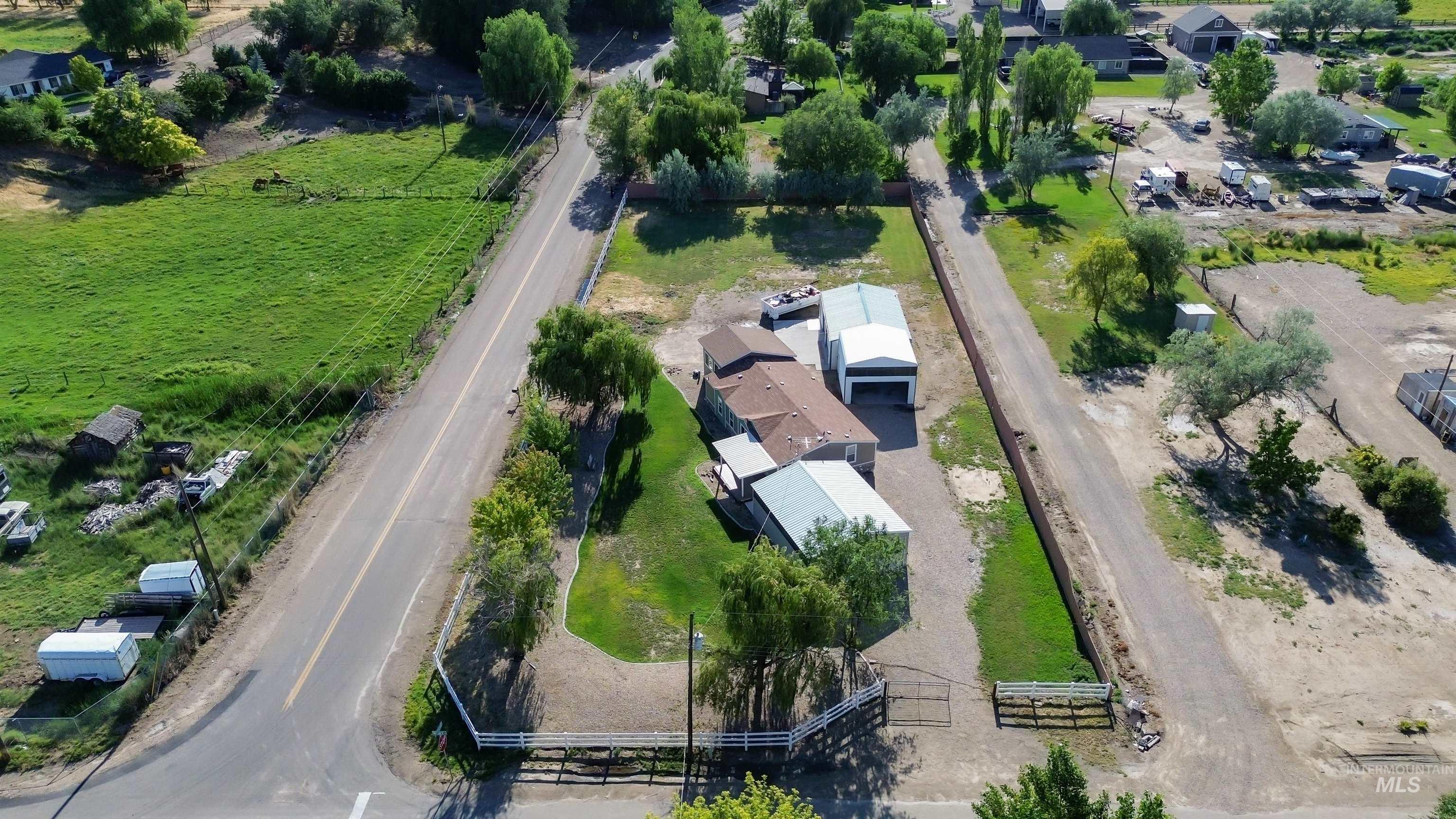 17028 Lower Pleasant Ridge Road Caldwell, ID 83607 - Photo 2 of 21 Spacious property featuring a main residence, an additional auxiliary structure, and a large metal outbuilding