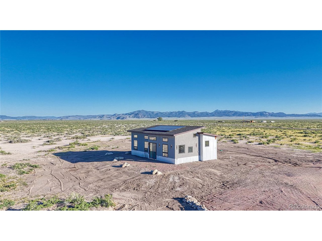 57884 Co Road Moffat, CO 81143 - Photo 5 of 40 South-facing windows capture passive solar.