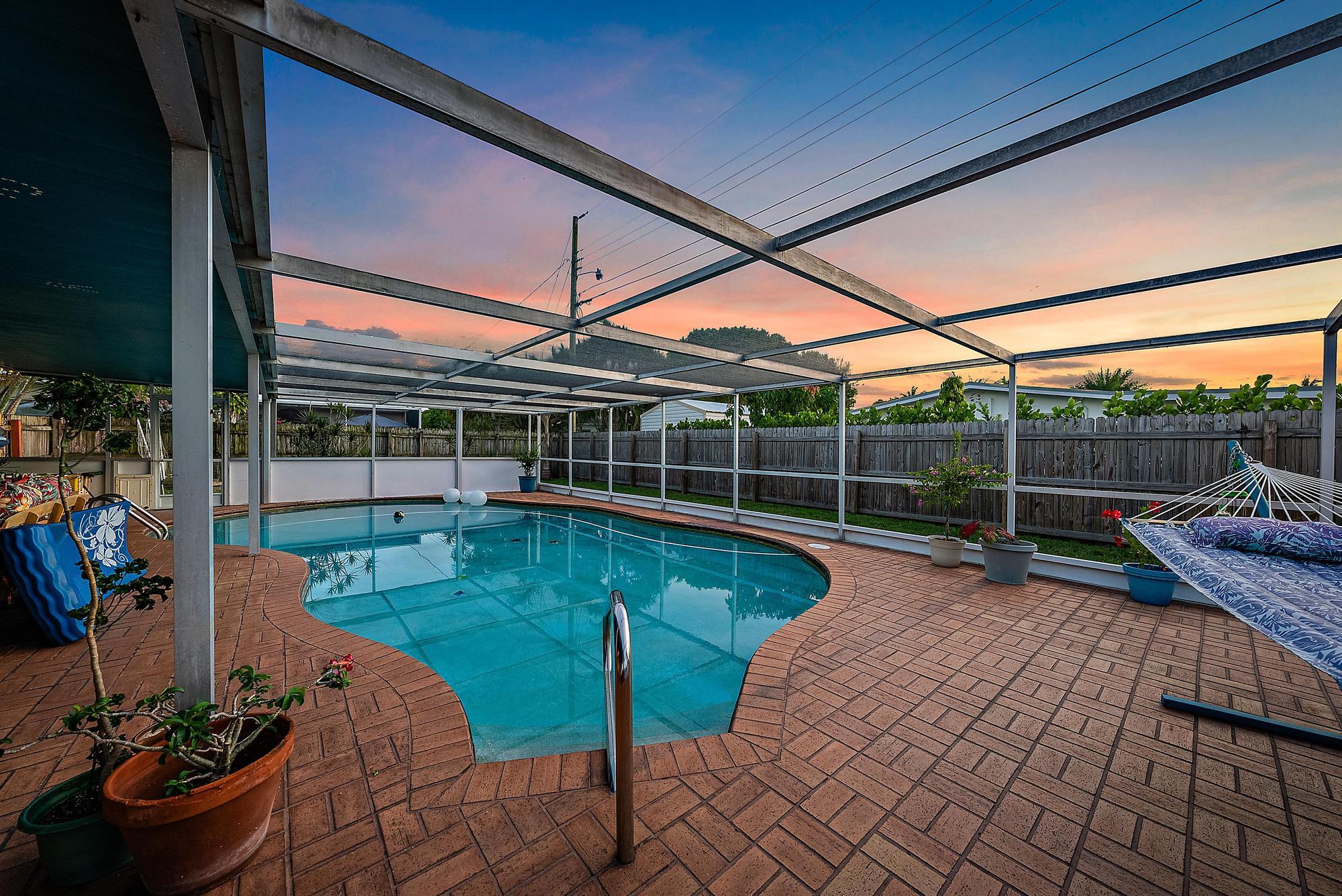 17659 Pittsburgh Drive Jupiter, FL 33458 - Photo 3 of 35 a view of a backyard with couches potted plants
