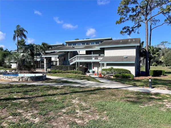 a view of a house with swimming pool and sitting area