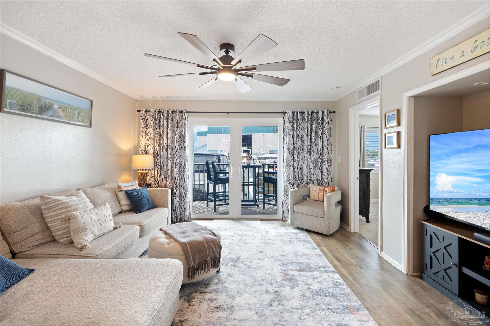 14100 River Road, Unit 122B Perdido Key, FL 32507 - Photo 3 of 46 a living room with furniture and a flat screen tv