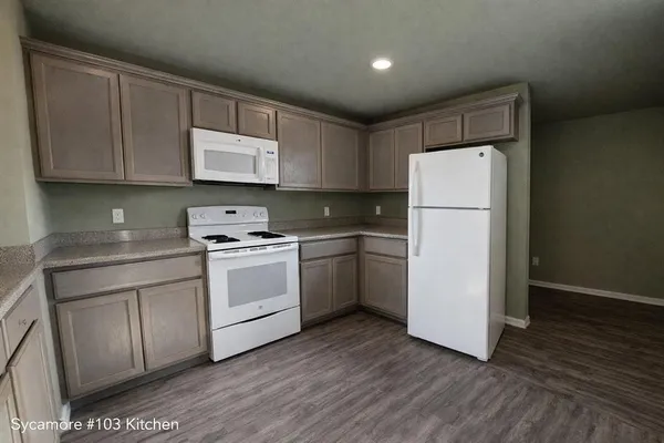 a kitchen with a white cabinets and white appliances