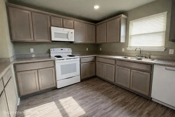a kitchen with a sink stove and cabinets