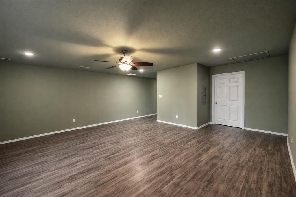 800 Sycamore Street, Unit 103 Commerce, TX 75428 - Photo 4 of 8 a view of an empty room with wooden floor