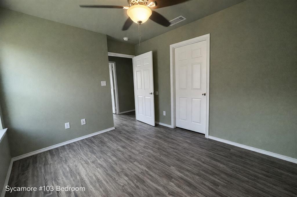 800 Sycamore Street, Unit 103 Commerce, TX 75428 - Photo 6 of 8 a view of an empty room with wooden floor