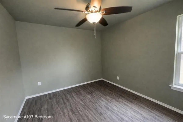 a room with a window and a fan