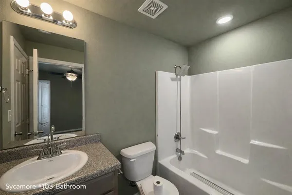 a bathroom with a sink toilet tub and shower