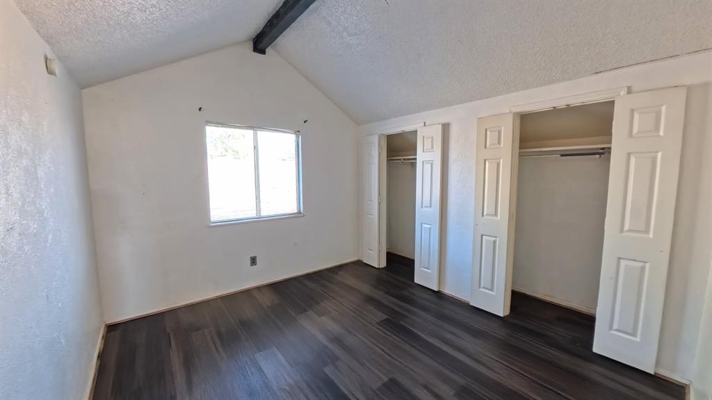 301 Gatewood Road Garland, TX 75043 - Photo 11 of 15 an empty room with wooden floor and windows