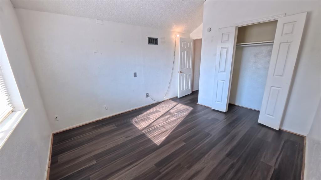301 Gatewood Road Garland, TX 75043 - Photo 8 of 15 a view of empty room with wooden floor