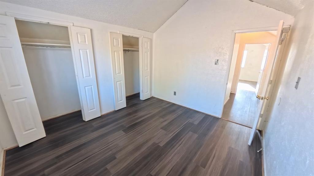 301 Gatewood Road Garland, TX 75043 - Photo 10 of 15 an empty room with wooden floor and closet area