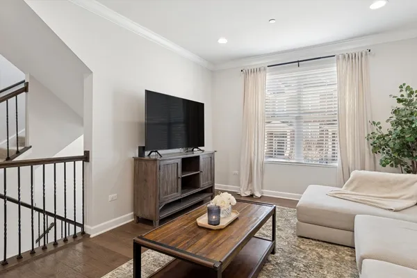 a living room with furniture a window and a flat screen tv