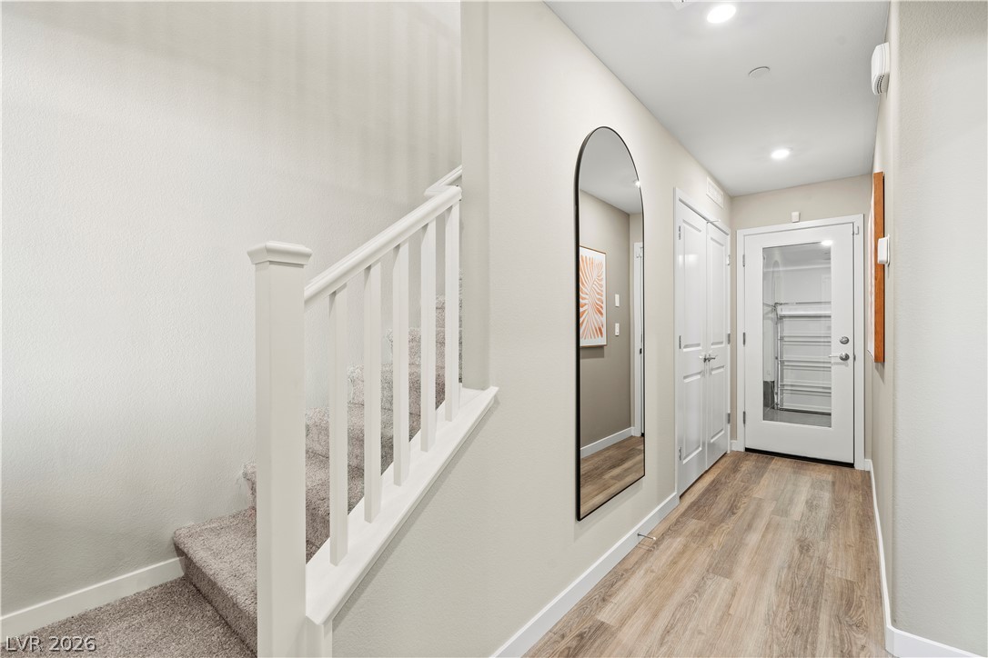 313 Keyboard Place Henderson, NV 89015 - Photo 6 of 22 A welcoming entryway with resilient wood-look flooring connects to a carpeted stairway.