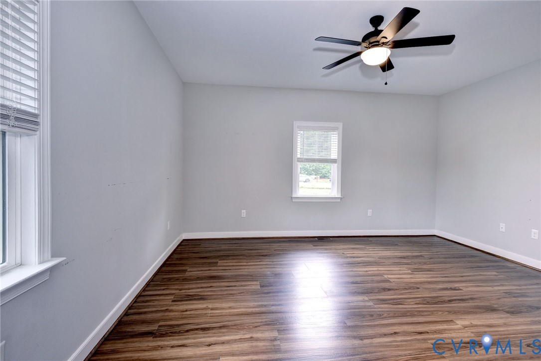 8904 Rock Cedar Road New Kent, VA 23124 - Photo 16 of 37 wooden floor in an empty room with a window