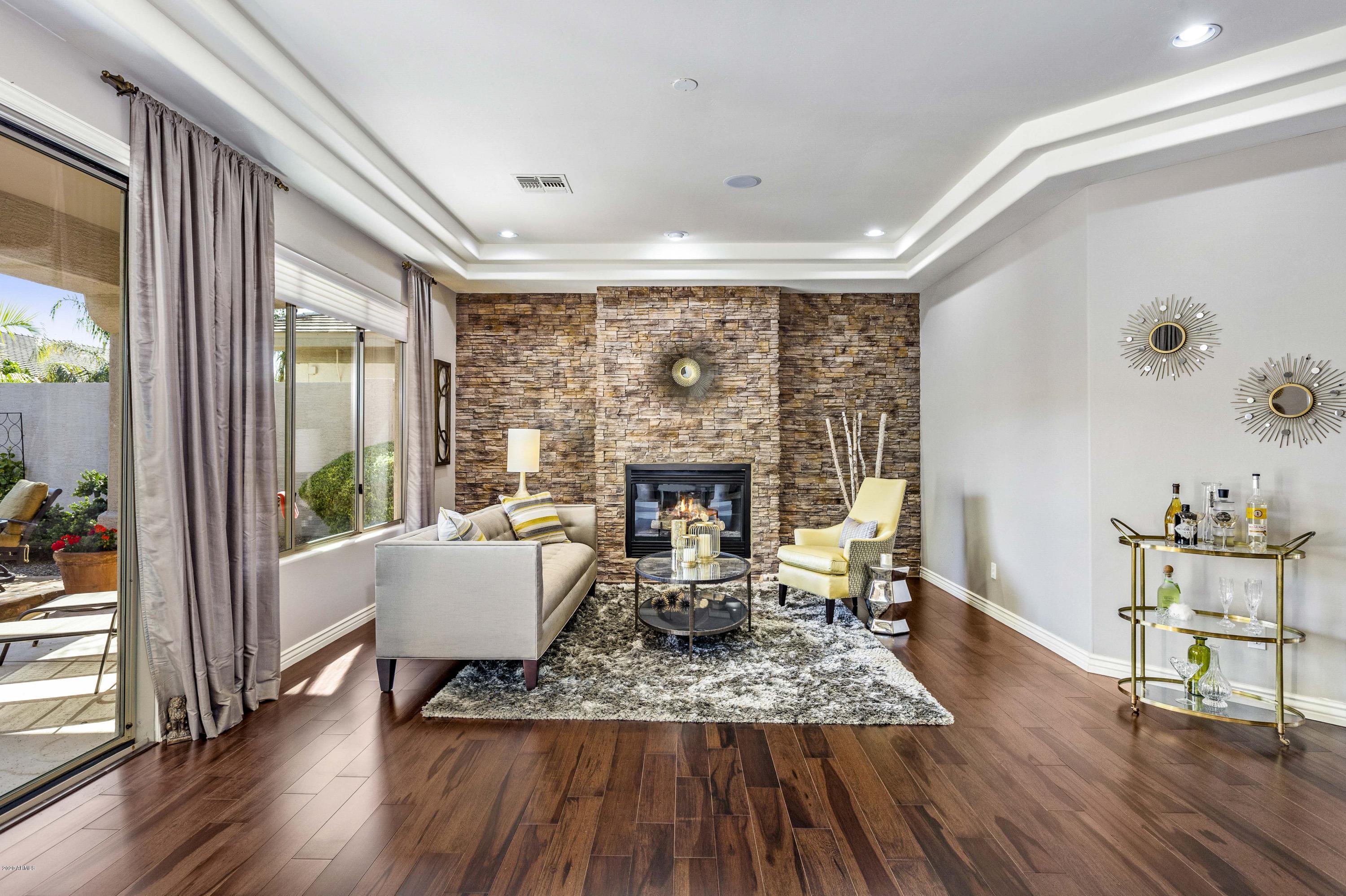 4583 East Desperado Road Gilbert, AZ 85297 - Photo 8 of 70 a living room with furniture and a fireplace