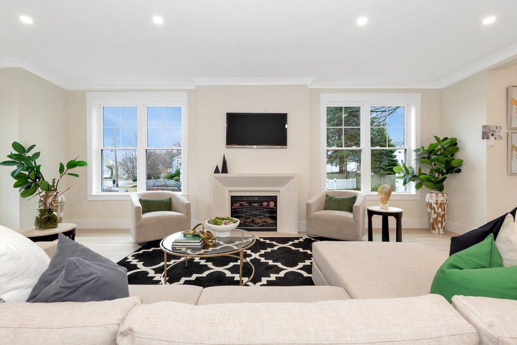 19 Cherokee Road Arlington, MA 02474 - Photo 14 of 42 a living room with furniture potted plant a fireplace and a window