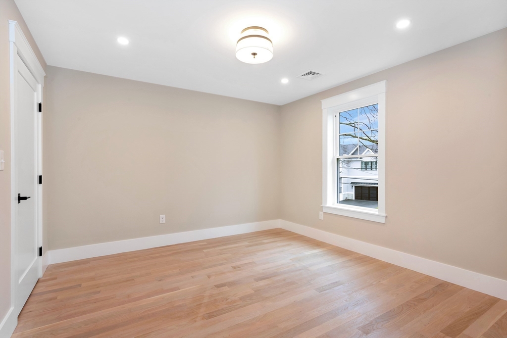 19 Cherokee Road Arlington, MA 02474 - Photo 23 of 42 wooden floor in an empty room with a window