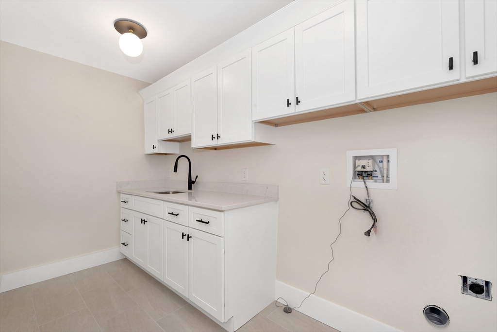 19 Cherokee Road Arlington, MA 02474 - Photo 25 of 42 a kitchen with a sink cabinets and appliances