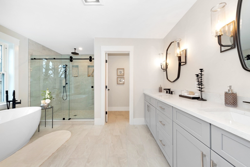 19 Cherokee Road Arlington, MA 02474 - Photo 28 of 42 a spacious bathroom with a double vanity sink toilet mirror and shower