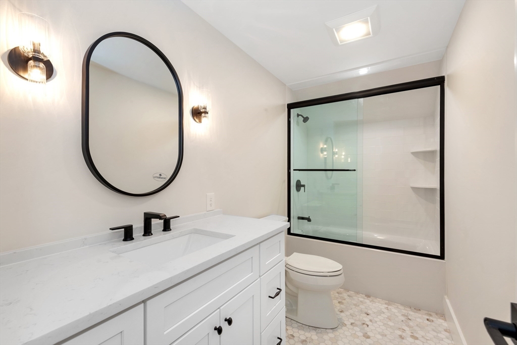 19 Cherokee Road Arlington, MA 02474 - Photo 33 of 42 a bathroom with a toilet a sink and mirror