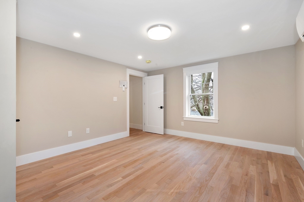 19 Cherokee Road Arlington, MA 02474 - Photo 34 of 42 a view of an empty room with wooden floor and a window