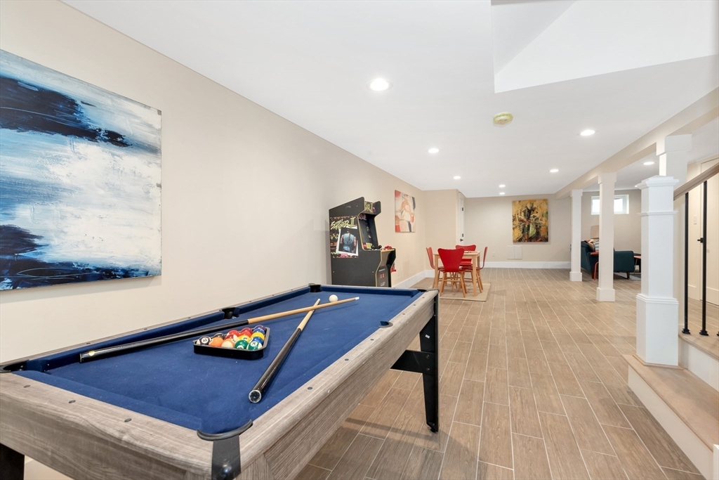 19 Cherokee Road Arlington, MA 02474 - Photo 35 of 42 a living room with furniture pool table and painting on the wall