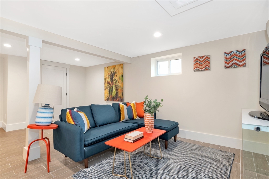 19 Cherokee Road Arlington, MA 02474 - Photo 36 of 42 a living room with furniture a rug and a window