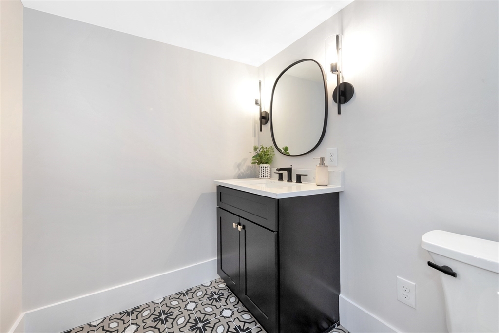 19 Cherokee Road Arlington, MA 02474 - Photo 38 of 42 a bathroom with a sink and a mirror