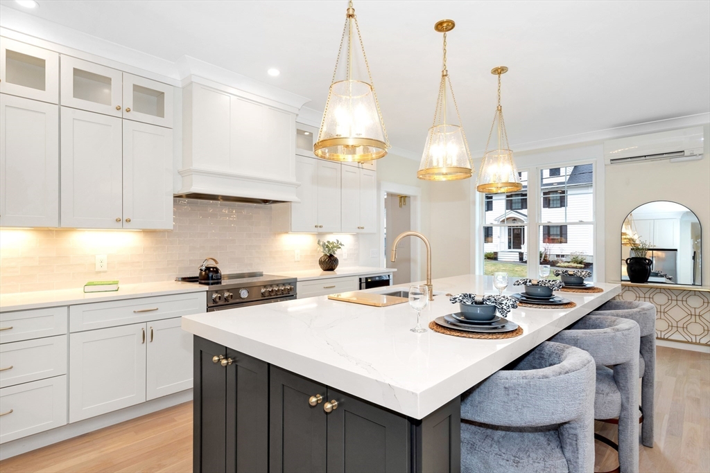 19 Cherokee Road Arlington, MA 02474 - Photo 6 of 42 a kitchen with a sink a stove a dining table and chairs