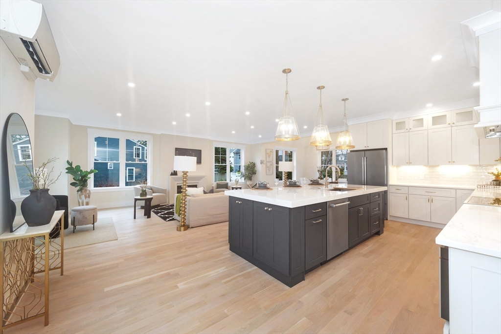 19 Cherokee Road Arlington, MA 02474 - Photo 9 of 42 a large kitchen with kitchen island a sink a counter space and stainless steel appliances