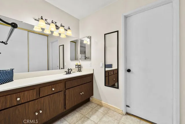 a bathroom with a granite countertop toilet and a shower