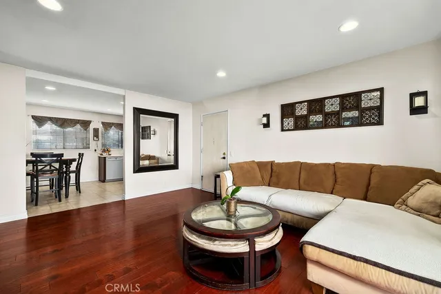 a living room with furniture and a wooden floor