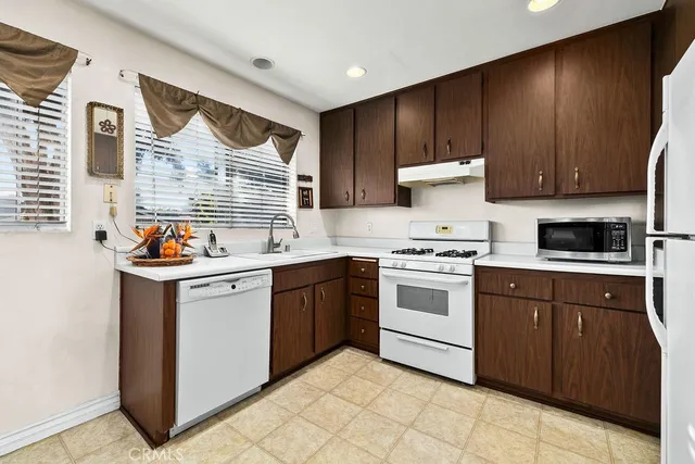 a kitchen with a stove sink and cabinets