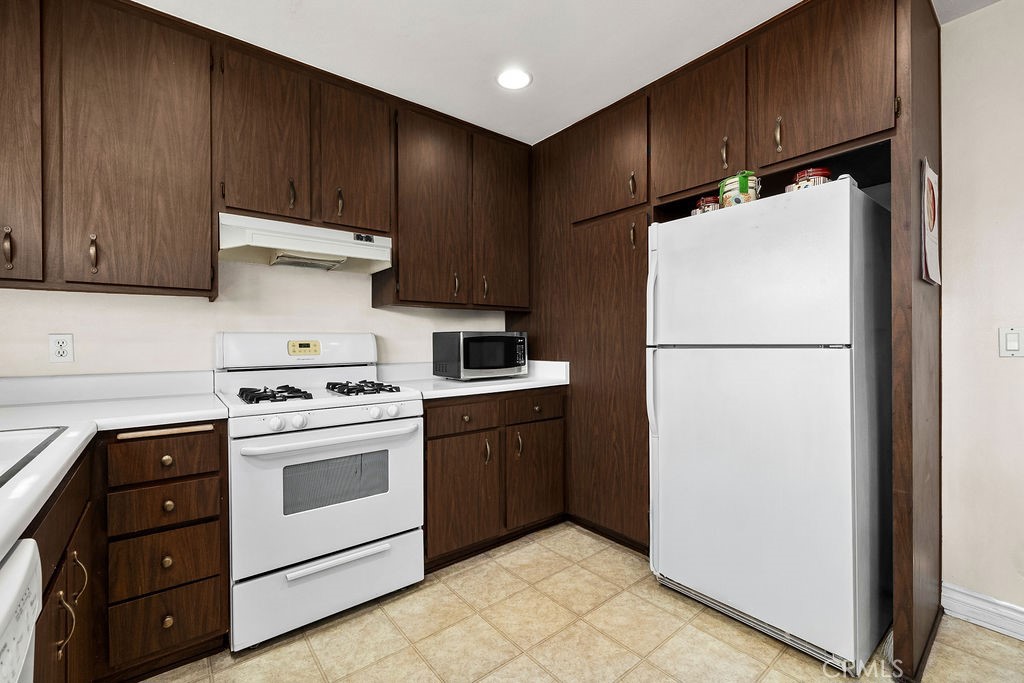 35 Firwood Irvine, CA 92604 - Photo 8 of 35 a kitchen with a refrigerator sink stove and cabinets